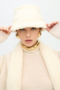 Cream sherpa bucket hat with soft plush texture and wide brim
