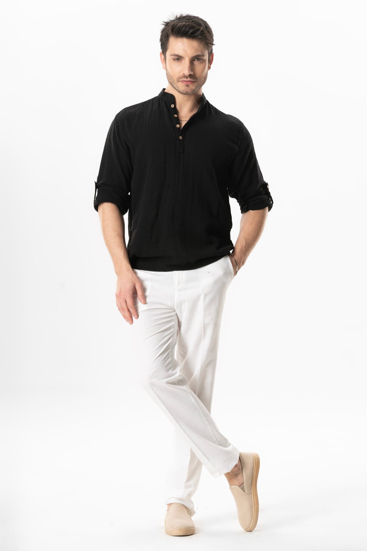 Man wearing a cotton black shirt and white pants
