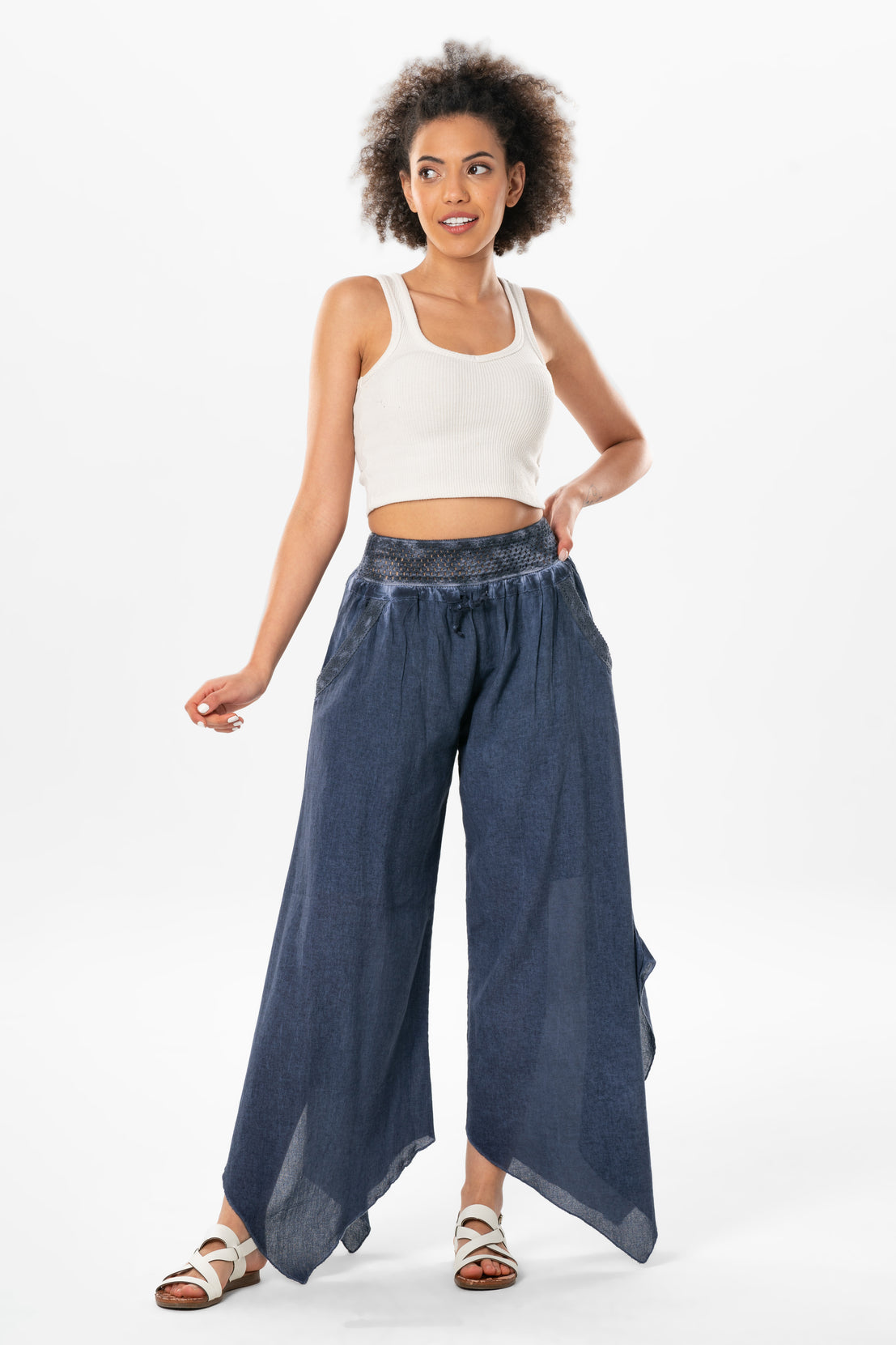 Woman wearing a white top and blue wide-leg pants