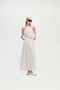 Cream strappy sleeveless top with ruffled neckline and peplum waist detail